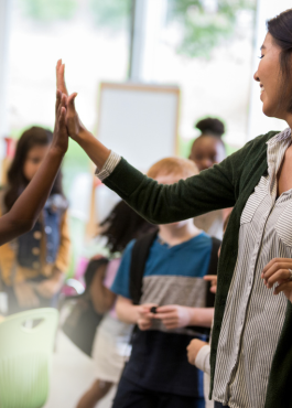 teacher highfiving student