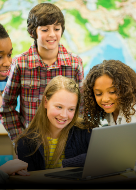 students looking around a laptop